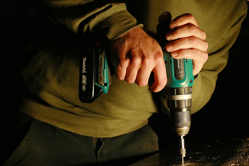 Makita DHP453 cordless drill with its battery attached