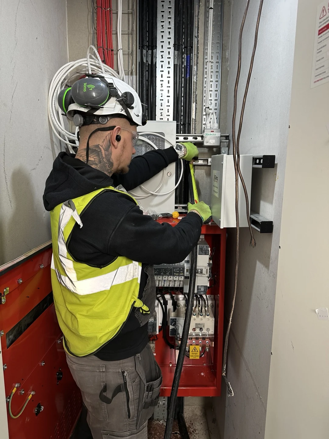 On-site electrical work at a distribution cabinet, with protective equipment in use